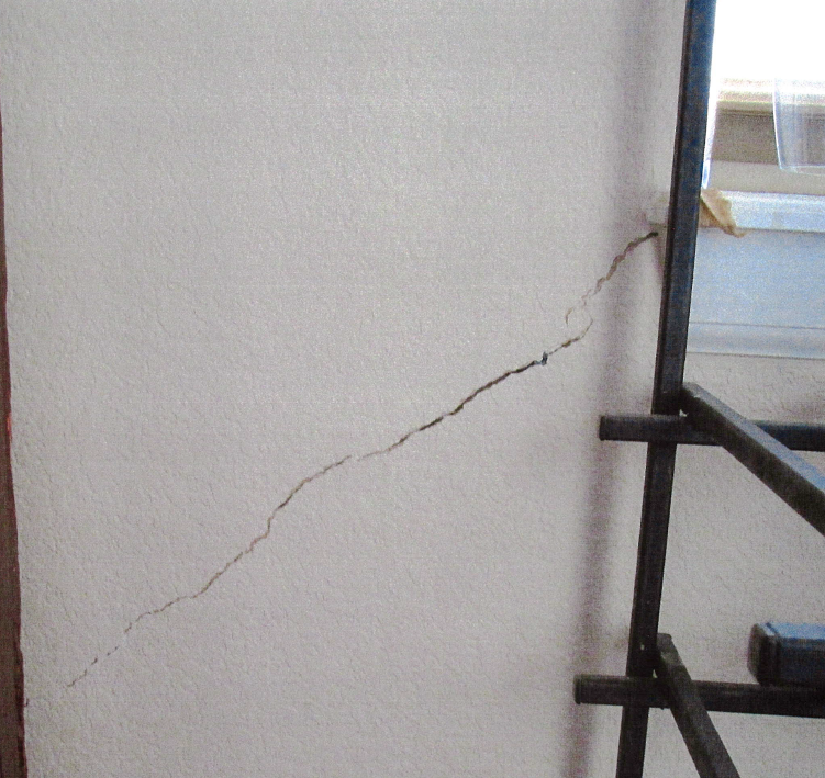Diagonal cracking from windows and door frames.